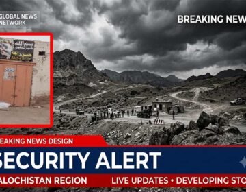 A security checkpoint and law enforcement vehicles cordoning off a street in rural Balochistan Pakistan