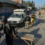 "Khyber Pakhtunkhwa police vehicle and security forces stationed following an ambush in DI Khan."