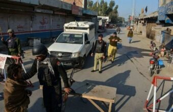 "Khyber Pakhtunkhwa police vehicle and security forces stationed following an ambush in DI Khan."