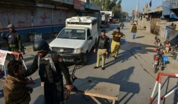 "Khyber Pakhtunkhwa police vehicle and security forces stationed following an ambush in DI Khan."
