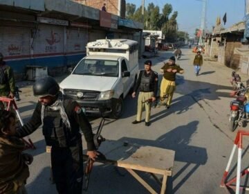 "Khyber Pakhtunkhwa police vehicle and security forces stationed following an ambush in DI Khan."