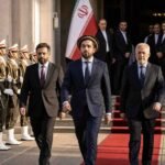 "Ahmad Massoud and the National Resistance Front (NRF) delegation walking on a red carpet at an official government reception in Tehran, flanked by Iranian honor guards."