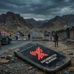 A smartphone with a glowing red 'No Service / Disconnected' blackout icon lying on a dusty road, flanked by security personnel patrolling a blocked mountain highway and closed market shops in Balochistan.