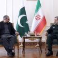 Pakistan Interior Minister Mohsin Naqvi meeting Iranian SNSC Secretary Mohsin Rezaei in Tehran with Pakistani and Iranian flags in the background