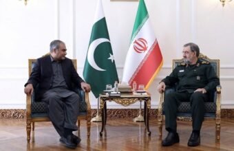 Pakistan Interior Minister Mohsin Naqvi meeting Iranian SNSC Secretary Mohsin Rezaei in Tehran with Pakistani and Iranian flags in the background