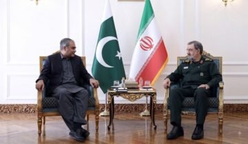 Pakistan Interior Minister Mohsin Naqvi meeting Iranian SNSC Secretary Mohsin Rezaei in Tehran with Pakistani and Iranian flags in the background