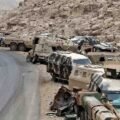Abandoned Saudi military armored vehicles and combat equipment lined up along a mountainous road near the Yemen border.