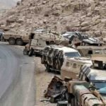 Abandoned Saudi military armored vehicles and combat equipment lined up along a mountainous road near the Yemen border.