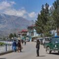 Representational view of a Badakhshan city with local residents, mountains and security personnel