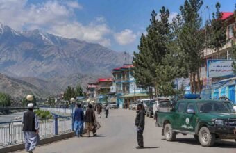 Representational view of a Badakhshan city with local residents, mountains and security personnel