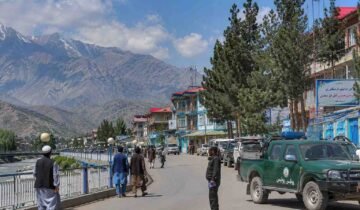 Representational view of a Badakhshan city with local residents, mountains and security personnel