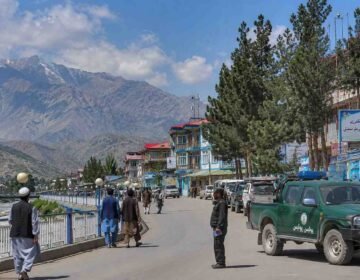 Representational view of a Badakhshan city with local residents, mountains and security personnel