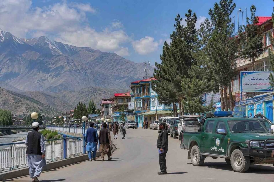 Representational view of a Badakhshan city with local residents, mountains and security personnel