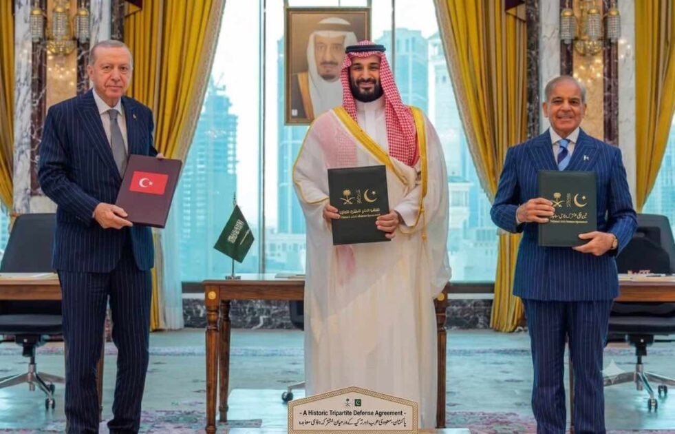 Turkish President Erdogan, Saudi Crown Prince MBS, and PM Shehbaz Sharif holding signed Pakistan Saudi Turkey defense agreement documents.