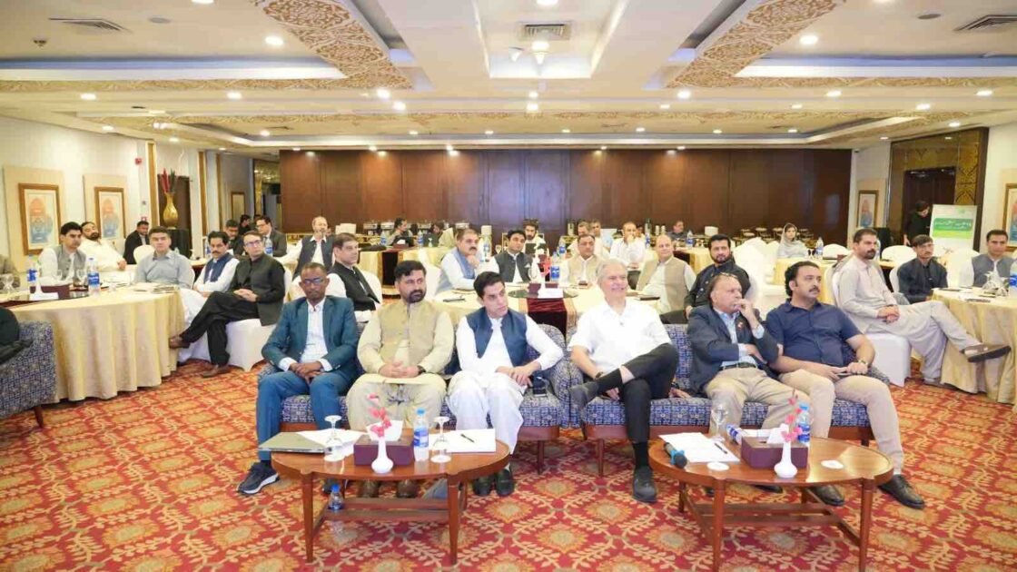 Health officials, journalists, and stakeholders seated in a conference hall during a polio awareness and eradication workshop.