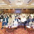 Health officials, journalists, and stakeholders seated in a conference hall during a polio awareness and eradication workshop.