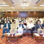 Health officials, journalists, and stakeholders seated in a conference hall during a polio awareness and eradication workshop.