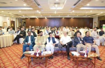 Health officials, journalists, and stakeholders seated in a conference hall during a polio awareness and eradication workshop.