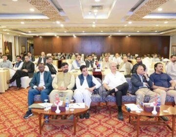 Health officials, journalists, and stakeholders seated in a conference hall during a polio awareness and eradication workshop.
