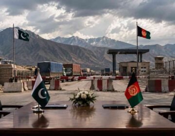 Pakistan-Afghanistan border crossing point with a negotiating table.