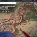 A close-up photograph of a large monitor displaying a satellite map of Pakistan, altered with a complex overlay of thick red lines creating a hypothetical subdivision of the country. At the top of the map, text in English reads: "PAKISTAN'S NEW ADMINISTRATIVE BOUNDARIES: A Fractured Nation?" Below it, Urdu text says: "پاکستان کا نیا انتظامی خاکہ: تقسیم در تقسیم؟" (translated as "Pakistan's New Administrative Plan: Division within Division?"). Numerous Urdu labels partition the map into smaller regions, including "جنوبی پنجاب" (South Punjab), "سرائیکستان" (Saraikistan), "پوٹوہار" (Pothohar), "مکران" (Makran), and "کراچی ریجن" (Karachi Region). Labels for adjacent territories like "INDIA", "AFGHANISTAN", "IRAN", "BALOMISTAN", "KARTAN", and "BHOJO" are also visible. A red pen tip is shown in the foreground near the bottom-center, poised near where "TANDO" (partially obscured) is written. The user interface mimics Google Maps, with a search bar and map controls. The background is a blurred view of multiple screens in a newsroom or control room.