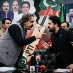 Tensions erupt into a direct confrontation between two men during a Pakistani political meeting, with other attendees attempting to keep them apart amidst a backdrop of political portraits and a fractured party symbol. Alt Text: A phot