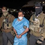 FBI agents escorting Afghan national and ISIS-K member Mohammad Sharifullah, convicted for the 2021 Kabul Abbey Gate bombing.