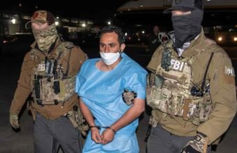 FBI agents escorting Afghan national and ISIS-K member Mohammad Sharifullah, convicted for the 2021 Kabul Abbey Gate bombing.