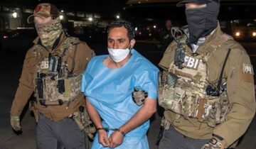 FBI agents escorting Afghan national and ISIS-K member Mohammad Sharifullah, convicted for the 2021 Kabul Abbey Gate bombing.