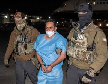FBI agents escorting Afghan national and ISIS-K member Mohammad Sharifullah, convicted for the 2021 Kabul Abbey Gate bombing.