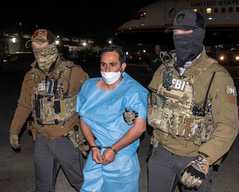 FBI agents escorting Afghan national and ISIS-K member Mohammad Sharifullah, convicted for the 2021 Kabul Abbey Gate bombing.