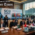 A high-level diplomatic signing ceremony at the SCO Summit in Islamabad, featuring world leaders seated at a long conference table with regional flags and official documents against a backdrop of the Margalla Hills and Faisal Mosque.