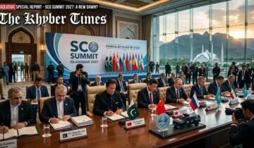 A high-level diplomatic signing ceremony at the SCO Summit in Islamabad, featuring world leaders seated at a long conference table with regional flags and official documents against a backdrop of the Margalla Hills and Faisal Mosque.