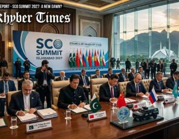 A high-level diplomatic signing ceremony at the SCO Summit in Islamabad, featuring world leaders seated at a long conference table with regional flags and official documents against a backdrop of the Margalla Hills and Faisal Mosque.