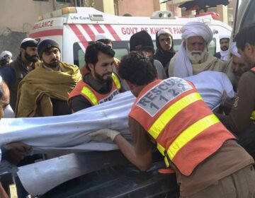 Rescue 1122 personnel and local residents carrying out relief operations following the attack on a traffic police mobile in Tank.
