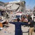 Rescue workers and Edhi ambulance at the collapsed private school building site in Dir Colony, Peshawar.