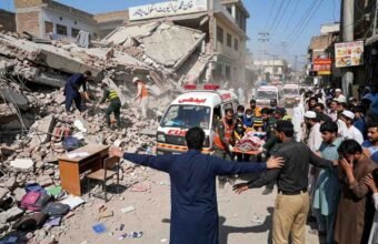 Rescue workers and Edhi ambulance at the collapsed private school building site in Dir Colony, Peshawar.