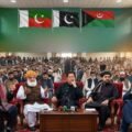 Prominent political leaders including Imran Khan, Maulana Fazlur Rehman, and regional figures seated together at a joint press conference in front of an audience and party flags.